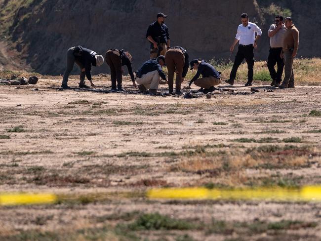 State prosecutors run a search at the site where Callum and Jake Robinson were camping with their friend Jack Carter Rhoad before they vanished. Picture: AFP