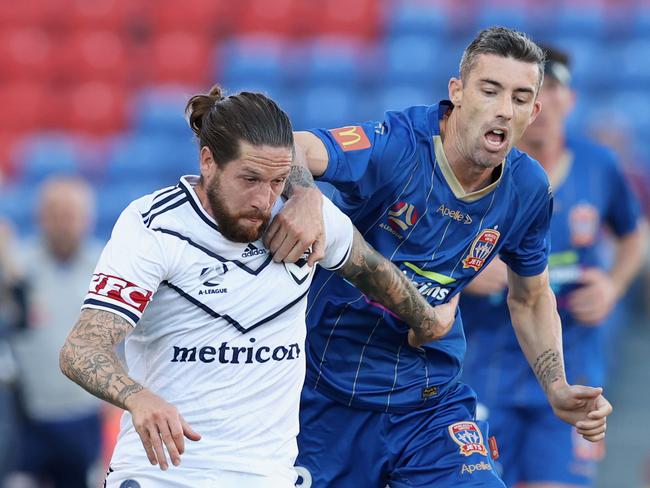 NEWCASTLE, AUSTRALIA - APRIL 10: Jacob Butterfield of Melbourne Victory contests the ball against Jason Hoffman of the Jets during the A-League match between the Newcastle Jets and the Melbourne Victory at McDonald Jones Stadium, on April 10, 2021, in Newcastle, Australia. (Photo by Ashley Feder/Getty Images)