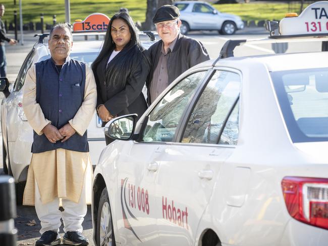 Taxi licence owners Devi Sharma and Tony Bell with community advocate and barrister Mala Crew at Hobart. Picture: Chris Kidd