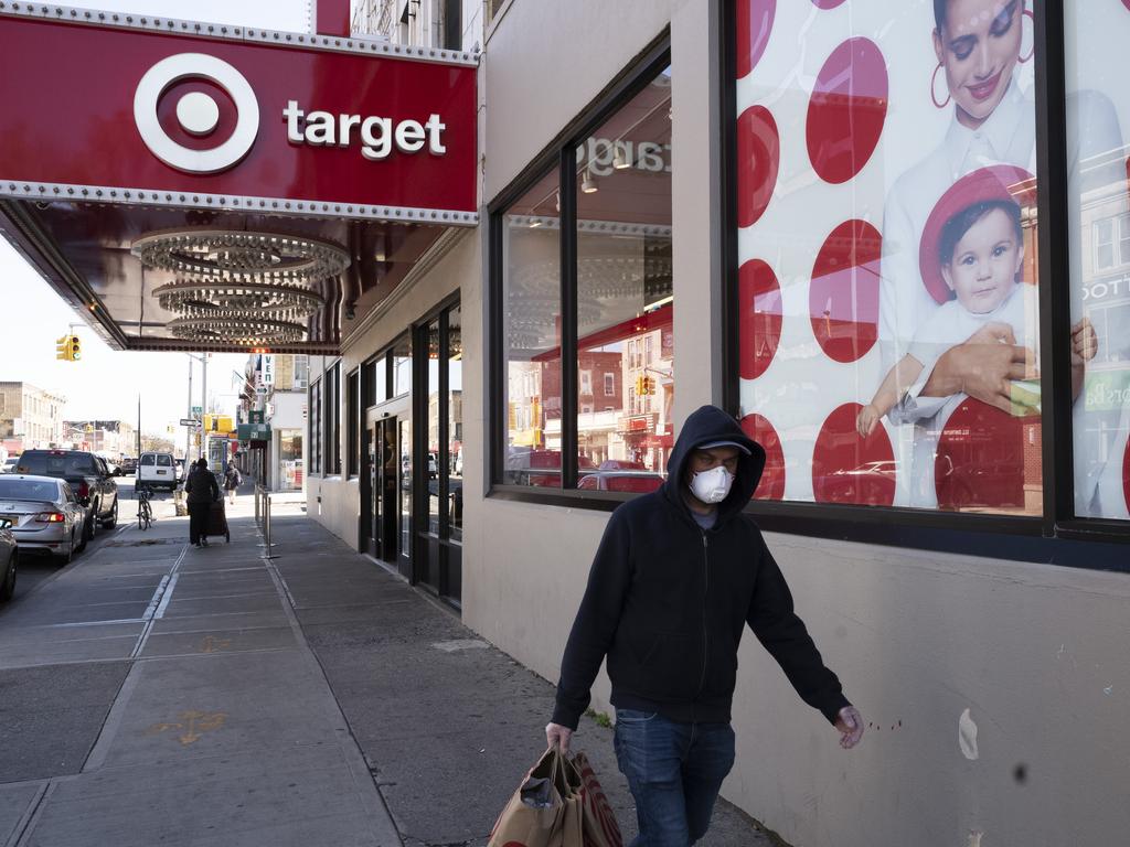 A customer wearing a mask carries his purchases as he leaves a Target store during the coronavirus pandemic, in Brooklyn, New York. Picture: AP Photo/Mark Lennihan, File
