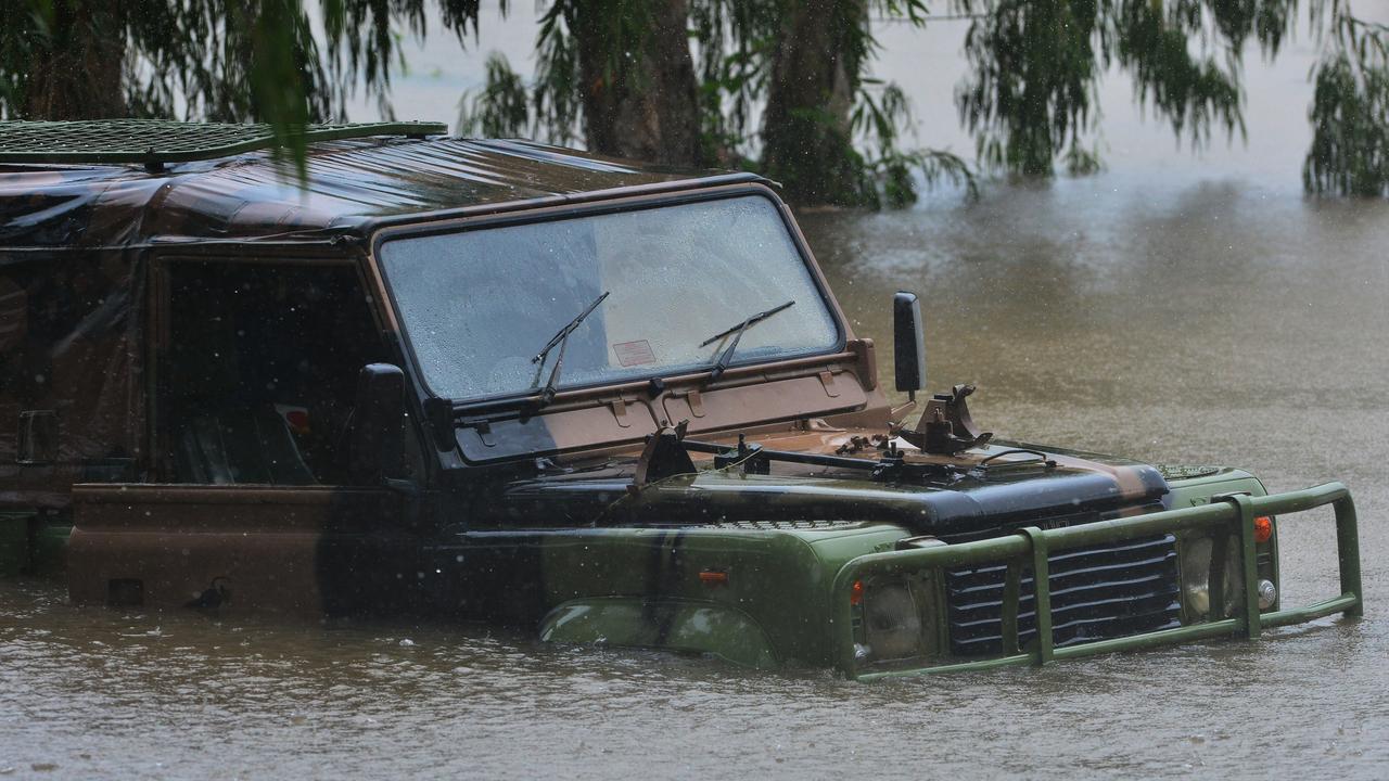 A man drove his car into flood waters at Loam Island, Rasmussen. Picture: Zak Simmonds