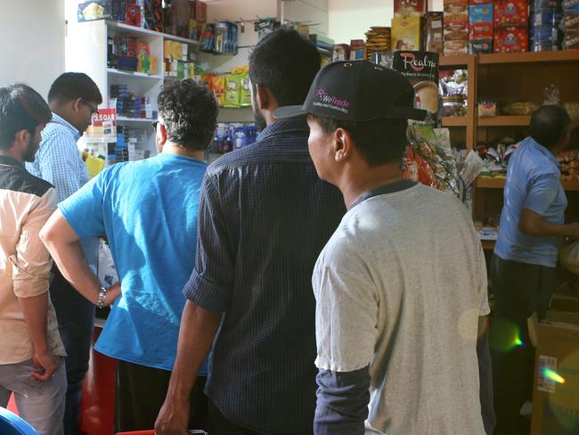 People buy snacks at a shop in Doha after Saudi Arabia closed its borders with Qatar, effectively blocking food and other supplies. Picture: AFP