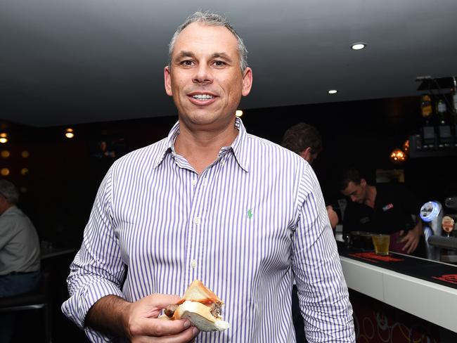 After surviving a very strange day in politics, NT Chief Minister Adam Giles did the only thing he could ... head to the pub for a beer and a sausage. Picture: Katrina Bridgeford