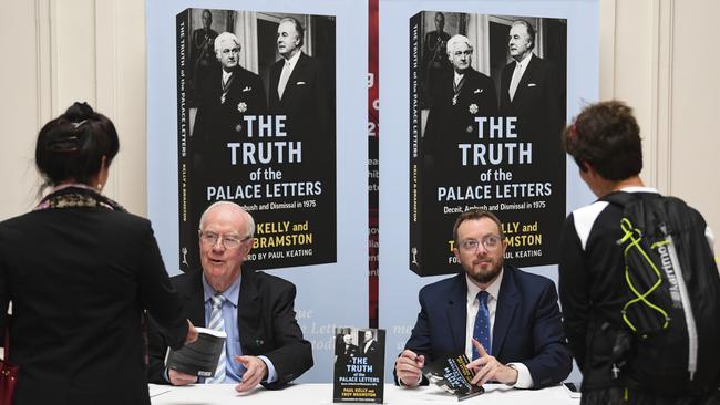 The Australian’s Paul Kelly, left, and Troy Bramston sign copies of their new book in Canberra on Wednesday. Picture: AAP