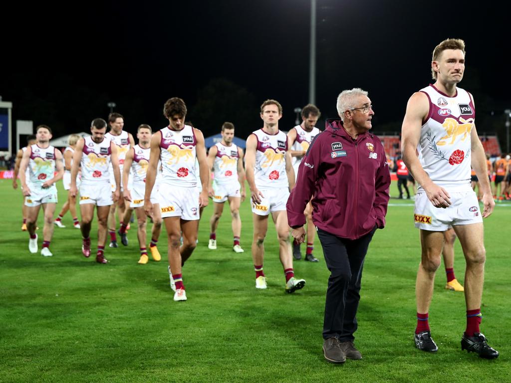 Coach Chris Fagan and co-captain Harris Andrews (right) lead the Lions off the field after their loss to the Giants. Picture: Jason McCawley/AFL Photos/via Getty Images