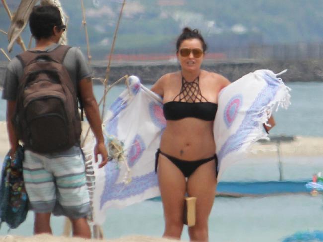 Schapelle Corby talks to her boyfriend Ben Panangian after sunbathing on the beach in Bali on April 3.