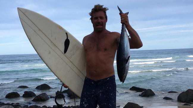 Nicholas Smith caught a Tuna in the ocean while surfing and had to fight off dolphins to keep it, he then went home and ate it.