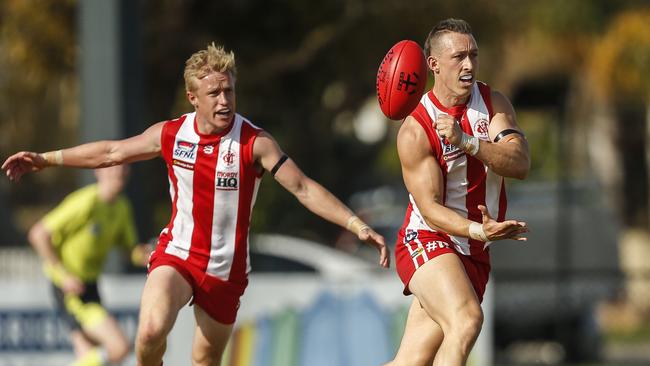 Dylan Gregson (right) fires of a handball for Mordialloc. Picture: Valeriu Campan