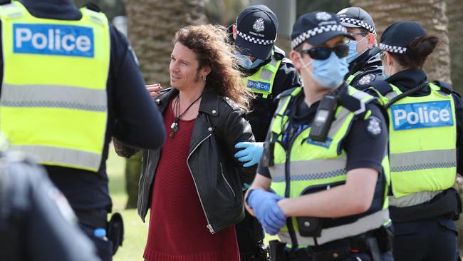 A protester is arrested in St Kilda. Picture: David Crosling