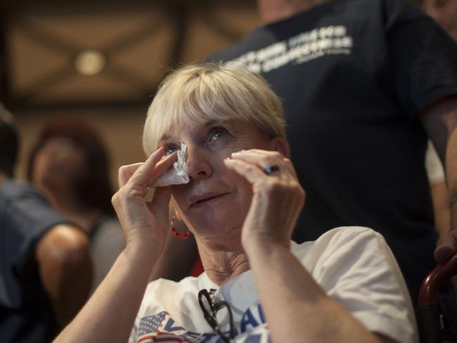 A supporter of Republican presidential candidate Donald Trump gets emotional watching televised results during an election night party at a hotel in downtown Phoenix, Arizona on November 8, 2016. Millions of Americans voted November 8th for their new leader in a historic election that will either elevate Democrat Hillary Clinton as their first woman president or hand power to maverick populist Donald Trump. / AFP PHOTO / Laura Segall
