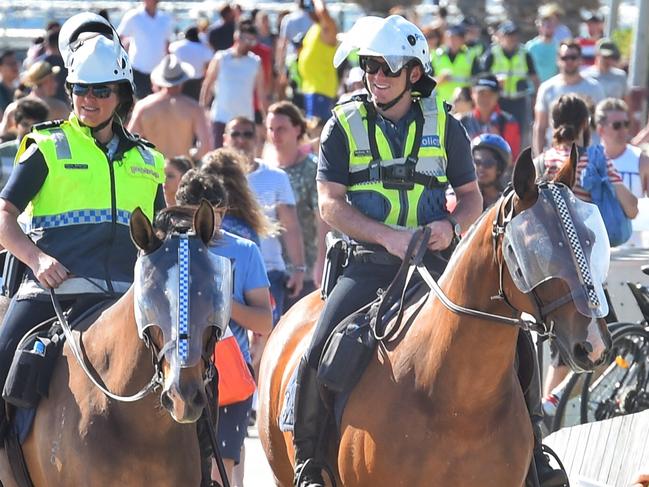 A large number of police were present at the St Kilda beach including members of the mounted police. Picture: Tony Gough