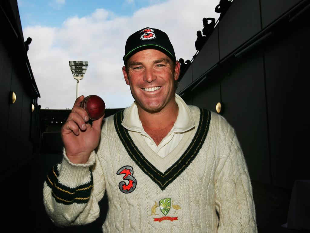 Pictured at the MCG in 2006, the late, great Shane Warne holds the ball he used to claim his 700th wicket. Like many kids around Australia and the world, Pat Cummins had a Warnie poster on his bedroom wall when he was a child. Picture: Phil Hillyard