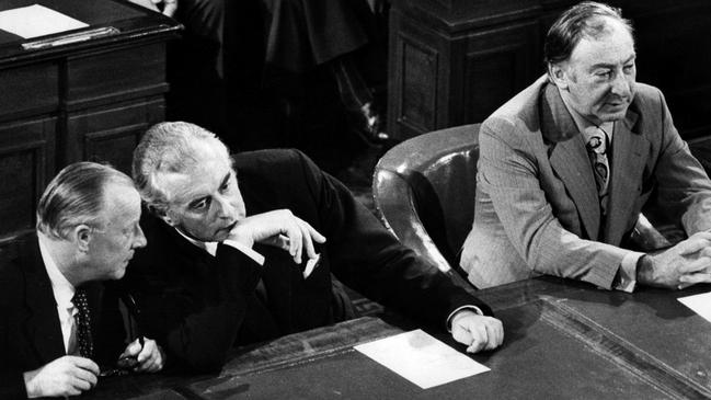 1973 : PM Gough Whitlam leans over to share a confidence with deputy PM Lance  Barnard (L) with Lionel Murphy during the ceremonial opening of Parliament in 1973. pic News Limited.