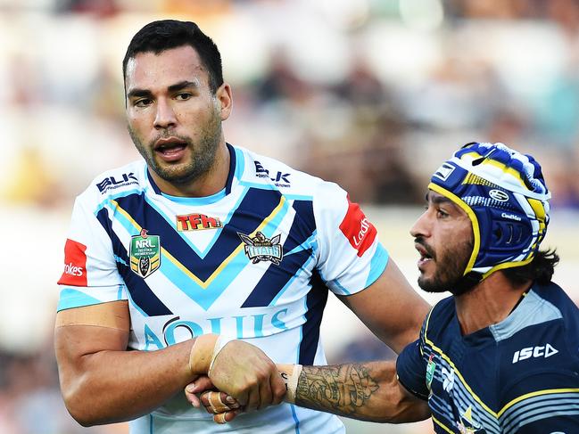 North Queensland Cowboys v Gold Coast Titans from 1300 Smiles Stadium,Townsville.  Titans Ryan James helps Cowboys Johnathan Thurston up.  Picture: Zak Simmonds