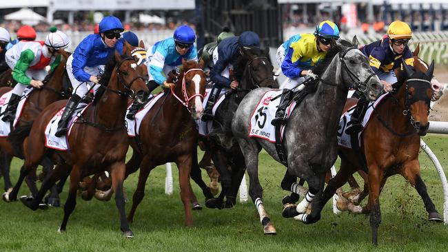 Jockey Pat Maloney (right) rides Vengeur Masque (right) ahead of Ryusei Sakai riding Sole Impact in the Caulfield Cup. Picture: AAP Image