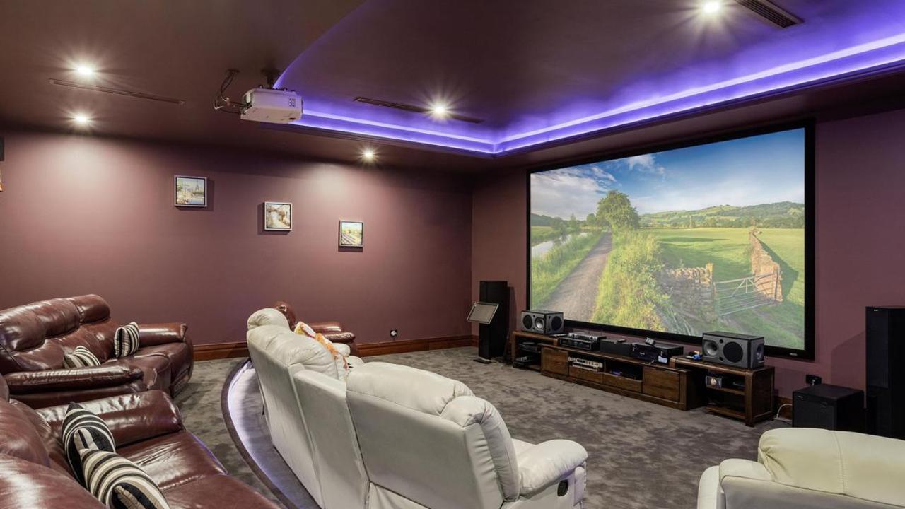 The home theatre features a projector and screen.