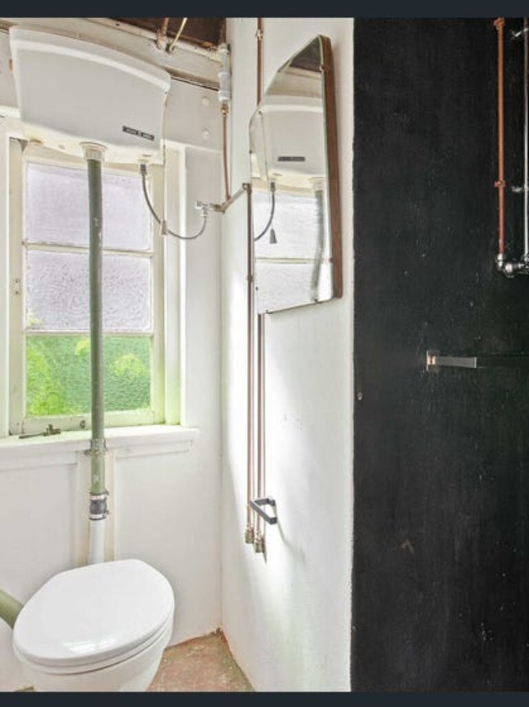 The bathroom, which is not tiled, and has the same black paint as the ceiling in the shower for some reason.