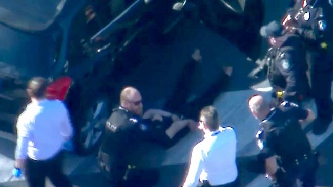 Police make an arrest after an attack on a security guard outside Westfield Helensvale Shopping Centre. Picture: 7News Brisbane