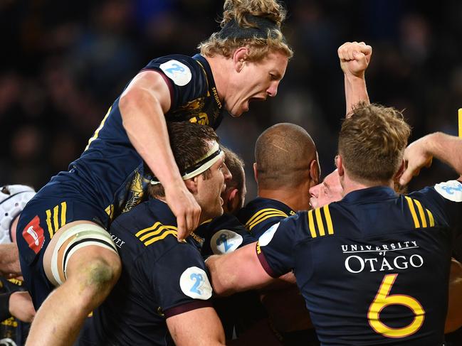 TOPSHOT - Otago Highlanders' James Lentjes (L) celebrates with teammates after victory during the rugby union match between the Otago Highlanders and the British and Irish Lions at Forsyth Barr Stadium in Dunedin on June 13, 2017.  / AFP PHOTO / Marty MELVILLE