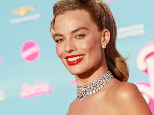 (FILES) Australian actress Margot Robbie arrives for the world premiere of "Barbie" at the Shrine Auditorium in Los Angeles, on July 9, 2023. Hollywood's pink wave has yet to crest as Warner Bros.' "Barbie" dominated for a third straight weekend in North American theaters, pushing the film's global haul past $1 billion in a first for a solo woman director, industry watcher Exhibitor Relations said August 6. The Greta Gerwig-directed blockbuster has tapped into a cultural zeitgeist: not only did it make history by hitting the billion-dollar box office milestone, it also did so faster than any film -- including those directed by men -- in Warner Bros.' 100-year history, executives there said. (Photo by Michael Tran / AFP)