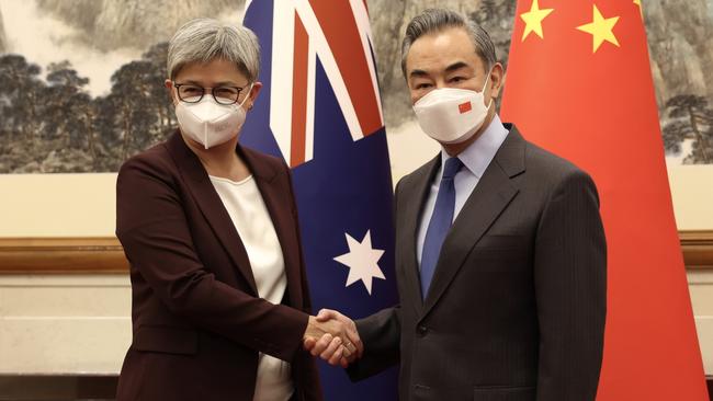 Australian Foreign Minister Penny Wong shakes hands with Chinese Foreign Minister Wang Yi at Diaoyutai State Guesthouse in Beijing on Wednesday.