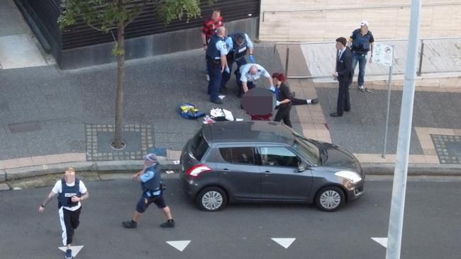 The body of Farhad Jabar lies outside Parramatta police station.