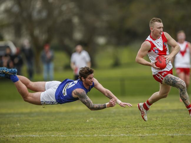 Sean Hewitt tries to tackle Karingal’s Lachlan Hinde. Picture: Valeriu Campan