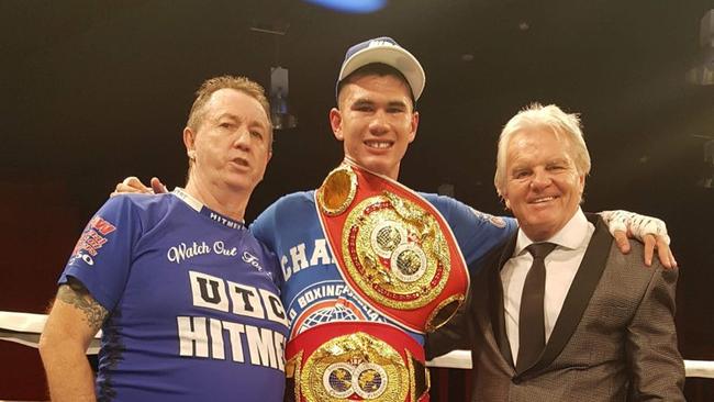 Reagan Dessaix with his coach Lincoln Hudson and ring announcer Rick Powelle.