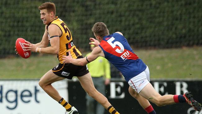 Damian Mascitti (left) shrugs a tackle while playing with Box Hill Hawks. Picture: Hamish Blair