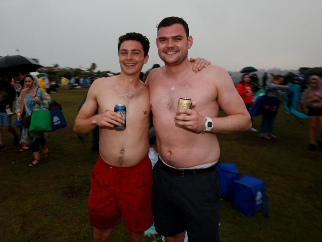 New Years Eve 2018 - 9pm Fireworks display from Dudley Page Reserve in Dover Heights. Liam Carbery (L) and Joe Larter enjoy a beer in the rain during a passing storm. Picture: Toby Zerna