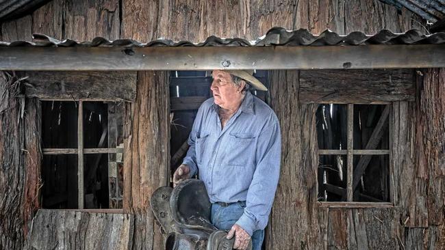 Bruce Green with his saddle and an old house prop he's taking up to the Brisbane Ekka as part of their show entertainment. Picture: Adam Hourigan