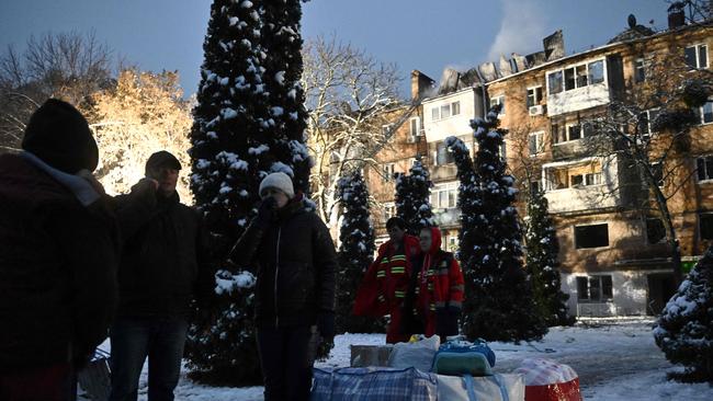 Residents with belongings rescued from a damaged residential building after a Russian strike in the town of Vyshgorod on the outskirts of Kyiv. Picture: Genya Savilov/AFP