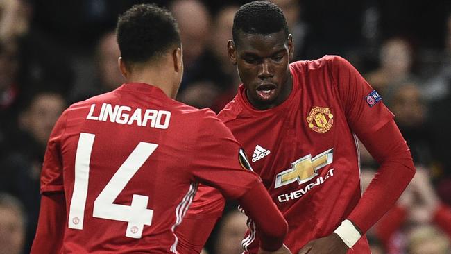 Manchester United's French midfielder Paul Pogba (R) with Jesse Lingard.