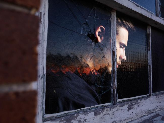 27 September 2024; Photo comp of a photo of a window of the dilapidated former Rozelle Hospital in Sydney, previously called Callan Park, was one of the largest mental asylums in the nation before it was shut and an image of a man's forlorn face looking outside the window; Sources: Max Mason-Huber and iStock. Photo comp by Emilia Tortorella. Ratio 16:9.