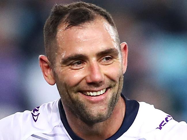 SYDNEY, AUSTRALIA - AUGUST 03: Cameron Smith of the Storm smiles as he watches on Cameron Smith during the round 21 NRL match between the South Sydney Rabbitohs and the Melbourne Storm at ANZ Stadium on August 3, 2018 in Sydney, Australia. (Photo by Mark Kolbe/Getty Images)