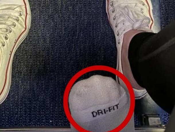 A passenger photographed the appalling moment when the flyer behind her poked their foot underneath their seat, as detailed in a viral Reddit post. Picture: Reddit/stefahnia
