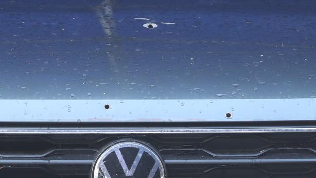 Bullet holes in a car outside the Edithvale home. Picture: David Crosling