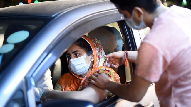 A woman receives the Sinopharm vaccine in Lahore. Picture: Arif ALI / AFP.