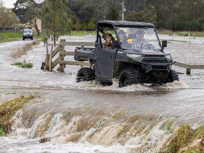 Flooding around the Macalister River flowing out of Lake Glenmaggie. A farmer drives through their flood water. Picture: Jason Edwards