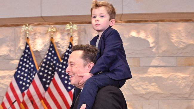 Mr Musk, co-chair of the newly created Department of Government Efficiency (DOGE), carries his son "X" on his shoulders. Picture: ROBERTO SCHMIDT / AFP)