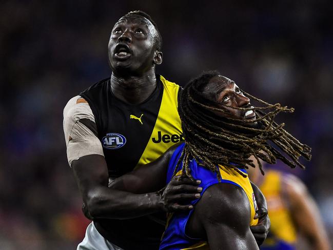 PERTH, AUSTRALIA - JUNE 13: Mabior Chol of the Tigers competes a throw-in with Nic Naitanui of the Eagles during the 2021 AFL Round 13 match between the West Coast Eagles and the Richmond Tigers at Optus Stadium on June 13, 2021 in Perth, Australia. (Photo by Daniel Carson/AFL Photos via Getty Images)