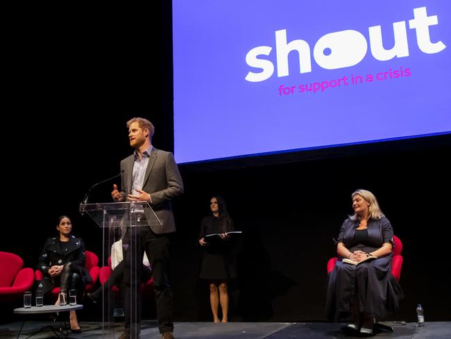 Prince Harry, centre, with Meghan (left) were supporting mental health support service, Shout. Picture: AFP 