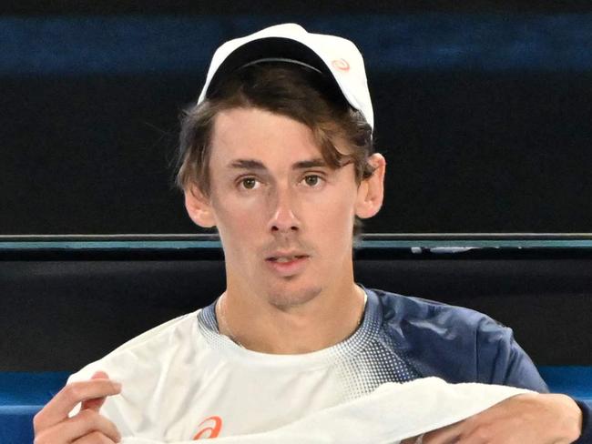 Australia's Alex De Minaur sits between games during his men's singles match against Italy's Jannik Sinner on day eleven of the Australian Open tennis tournament in Melbourne on January 22, 2025. (Photo by WILLIAM WEST / AFP) / -- IMAGE RESTRICTED TO EDITORIAL USE - STRICTLY NO COMMERCIAL USE --