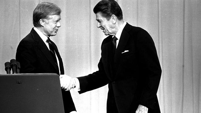 US President Jimmy Carter, left, and Republican Presidential candidate Ronald Reagan shake hands in Cleveland in October 1980, prior to a debate in front of a nationwide television audience.