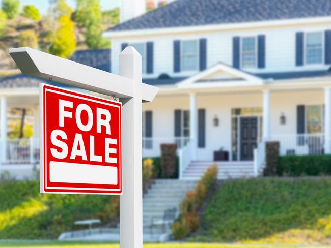 For Sale Real Estate Sign in Front of New House.