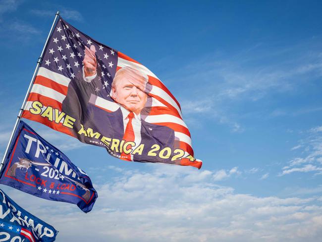 PALM BEACH, FLORIDA - NOVEMBER 29: Flags in support of U.S. President-elect Donald Trump blow near the Mar-a-Lago Club on November 29, 2024 in Palm Beach, Florida. President-elect Trump has been residing at the club and announcing nominees as he continues filling out his cabinet for his upcoming administration.   Brandon Bell/Getty Images/AFP (Photo by Brandon Bell / GETTY IMAGES NORTH AMERICA / Getty Images via AFP)