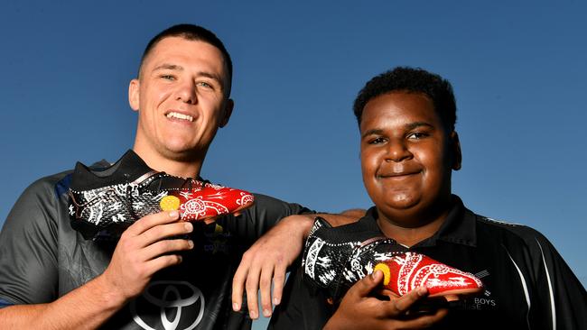 North Queensland Cowboys player Scott Drinkwater with Cowboys House student Elson Asai, 13, from Yorke Island in the Torres Strait with the painted boots. Picture: Evan Morgan