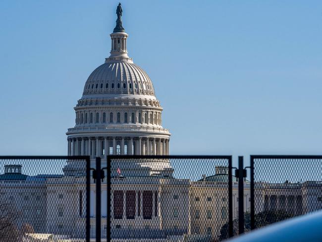 The US Capitol building is seen past security fencing on the National Mall ahead of the January 6th certification of the 2024 Presidential Election in Congress in Washington, DC, on January 5, 2025. (Photo by Allison ROBBERT / AFP)