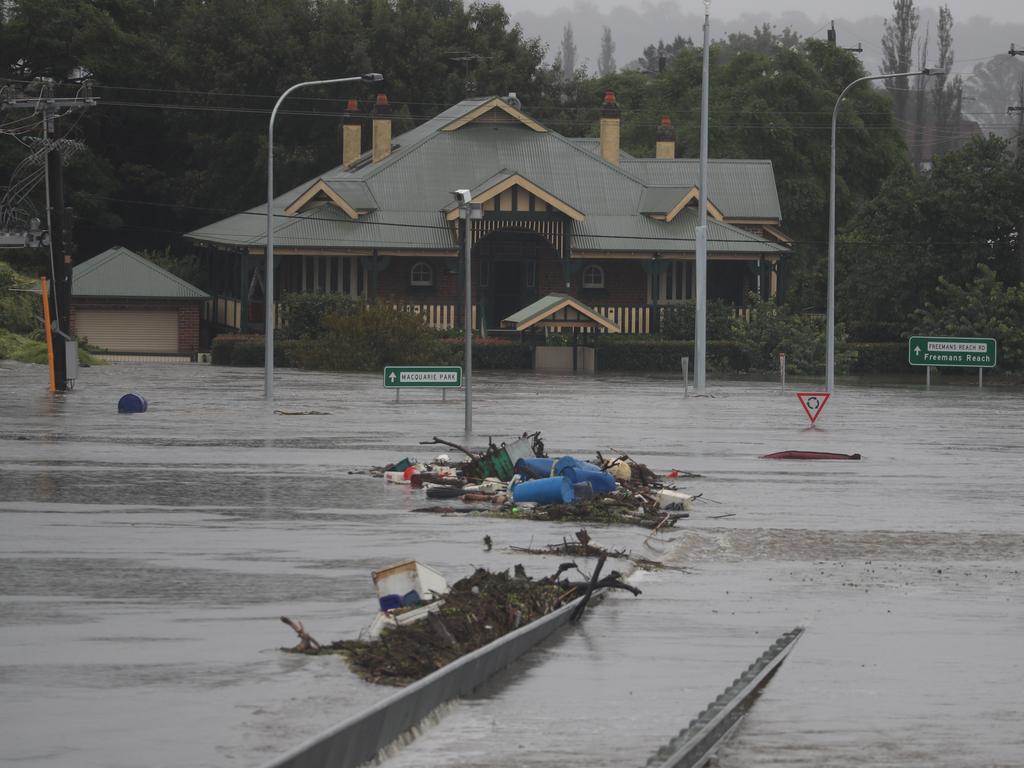 Daylight revels how high the water has risen over night at the Unfloodable Windsor bridge and surrounding streets. Picture: John Grainger