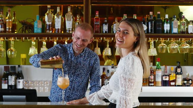 Bartender Kieron Walsh pours a cocktail for Jamie Binder at the Whisky and Wine bar at Crystalbrook Flynn. Crystalbrook area manager Joel Gordon says providing an enhanced cleaning regimen was a balancing act. Picture: Brendan Radke